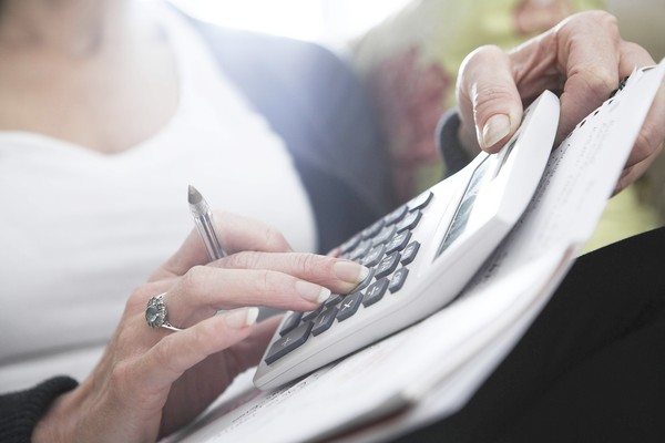 Close-up of woman's hands on calculator ** TCN OUT **